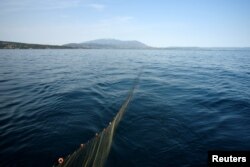 A fishing net from Panagiotis Pagonis' boat "Katerina" floats off the shore of Asprovalta, Greece, June 11, 2018.