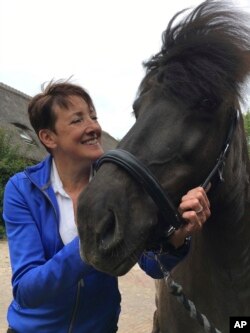Els van der Heijden, a cystic fibrosis patient, stands with her Icelandic horse in Hekendorp, Netherlands, June 8, 2017.