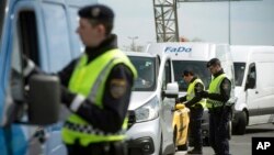 FILE - Austrian policemen check vehicles on the Austrian side of the Hungarian-Austrian border near Nickelsdorf, 70 kms southeast of Vienna, April 25, 2016.