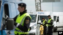 FILE - Austrian policemen check vehicles on the Austrian side of the Hungarian-Austrian border near Nickelsdorf, 70 kms southeast of Vienna, April 25, 2016.