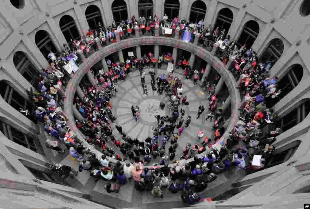 Members of the transgender community and others who oppose Senate Bill 6, protest in the exterior rotunda at the Texas state Capitol as the Senate State Affairs Committee holds hearings on the bill, in Austin, Texas.