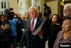 FILE - U.S. House Minority Whip Steny Hoyer speaks to reporters at the Capitol in Washington.