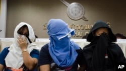 Unidentified Thai suspects of human trafficking appear at a news conference at police headquarters in Bangkok, Thailand, Aug. 4, 2015.