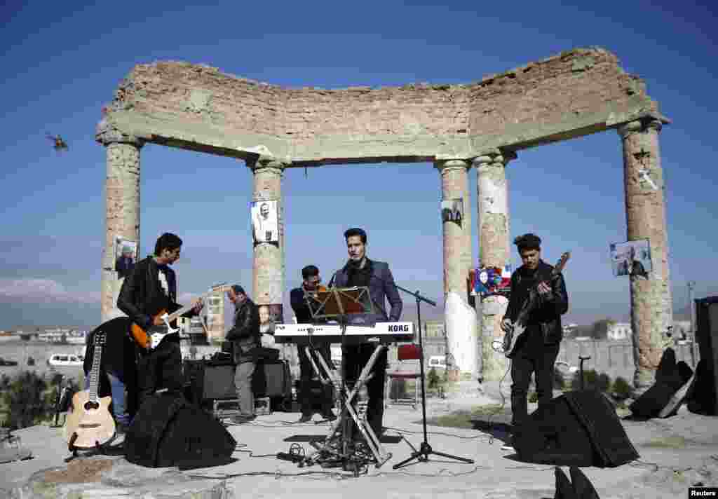 An Afghan band performs at the ruins of Darul Aman palace in Kabul during a campaign called &quot;One Thousand Smiles for Peace&quot; by Non-Violent World Organization (NVWO).