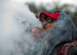 Demonstrator vapes outside of the White House to protest the proposed vaping flavor ban in Washington DC on November 9, 2019. (Photo by Jose Luis Magana / AFP)