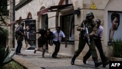 Kenyan security forces help people escape after a blast at Dusit D2 hotel in Nairobi, Kenya, Jan. 15, 2019. A blast followed by a gun battle rocked the hotel and office complex in Nairobi, causing casualties, in an attack claimed by the Al-Qaida-linked Al-Shabab Islamist group.