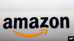 FILE - Amazon's logo. Amazon is attempting to develop glasses that pair with Alexa and would allow users to access the voice-activated assistant outside the home, according to a newspaper report, Sept. 20, 2017