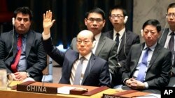 Chinese Ambassador to the United Nations Liu Jieyi votes during a Security Council meeting at U.N. headquarters on a new sanctions resolution that would increase economic pressure on North Korea to return to negotiations on its missile program, Aug. 5, 2017.
