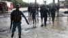 FILE - Afghan police soldiers inspect the site of a suicide attack in Kabul, Afghanistan, Monday, June 20, 2016.