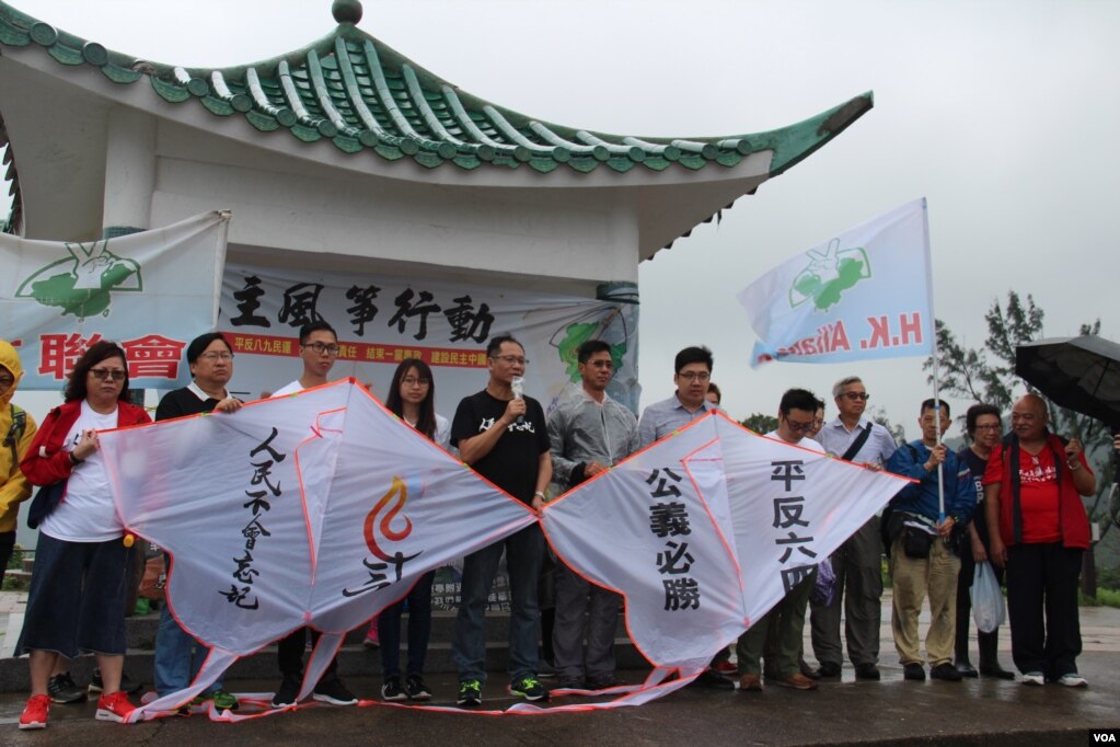 资料照：香港支联会副主席蔡耀昌（中间讲话者）及其成员冒雨举行六四风筝放飞行动。(photo:VOA)