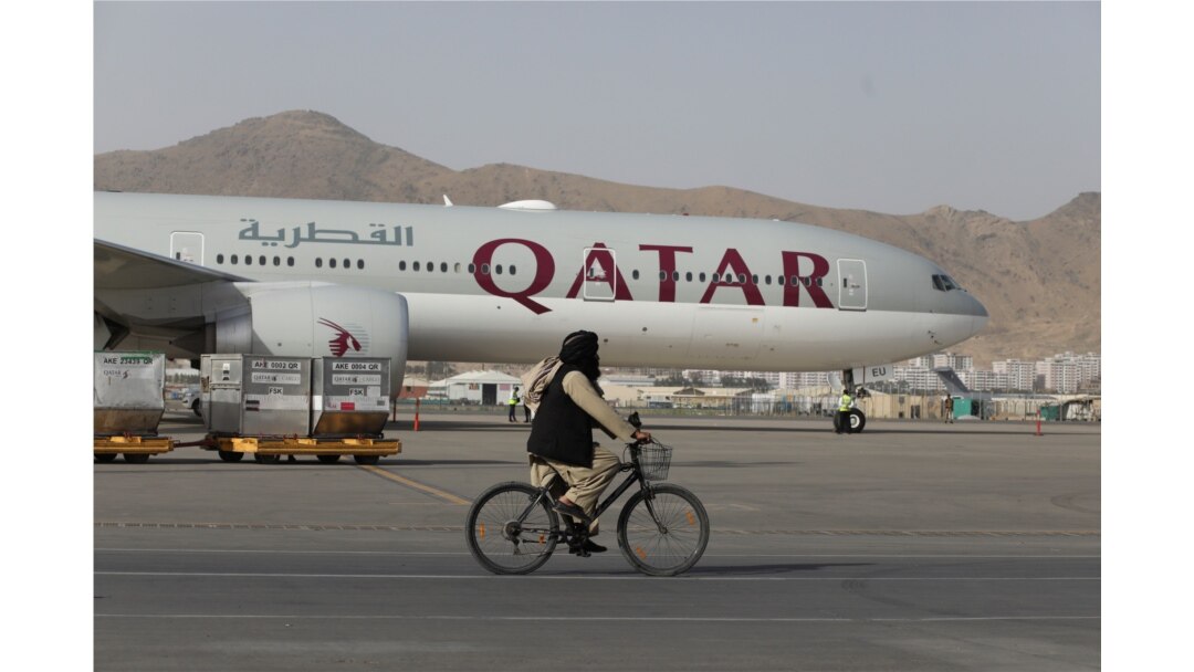 FILE - A Taliban soldier patrols on a bike in front of a Qatar Airways flight at the international airport in Kabul, Afghanistan, September 10, 2021. (West Asia News Agency via Reuters)