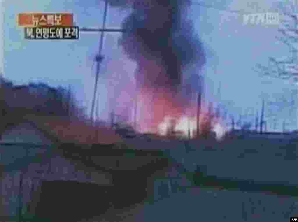 In this image take from TV footage, smoke rises from South Korea's Yeonpyeong island near the border against North Korea, Tuesday, Nov. 23, 2010. North Korea shot dozens of rounds of artillery onto the populated South Korean island near their disputed wes