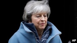 FILE - Britain's Prime Minister Theresa May leaves 10 Downing Street in London, Feb. 12, 2019. 