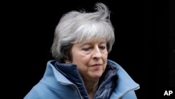 Britain's Prime Minister Theresa May, who is expected to address Parliament Tuesday, leaves 10 Downing Street in London, Feb. 12, 2019. 