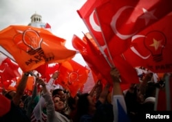 People wave flags during Turkey's Prime Minister Tayyip Erdogan speech at his rally in Ankara, June 15, 2013.