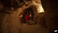 FILE: A tourist visits the inside of the Great Pyramid, built by Cheops, known locally as Khufu in Giza, Egypt, June 2, 2016. A scientific team scanning the Great Pyramid aimed at discovering the famed pharaonic monument's secrets including possible hidden burial chambers.