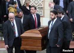 A casket is carried from Rodef Shalom Temple after funeral services for brothers Cecil and David Rosenthal, victims of the Tree of Life Synagogue shooting, in Pittsburgh, Pennsylvania, Oct. 30, 2018.