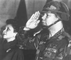 FILE - In this Dec. 30, 1986, file photo, U.S. Lieutenant General Colin Powell, commander of the 5th U.S. corps, salutes while his wife Alma stands in attention during a farewell ceremony in Frankfurt. (AP Photo/Udo Weitz)