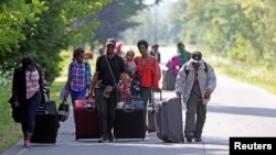 Three families, who said they were from Burundi, head to Canada to seek asylum, Aug. 3, 2017, Thousands of immigrants, awaiting the outcome of their US asylum application but fearing deportation under President Donald Trump, made the journey to Canada. 