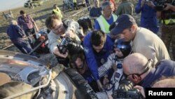 Ground personnel help International Space Station (ISS) crew member Thomas Pesquet of France to get out of a capsule after landing in a remote area outside the town of Dzhezkazgan (Zhezkazgan), Kazakhstan, June 2, 2017. 