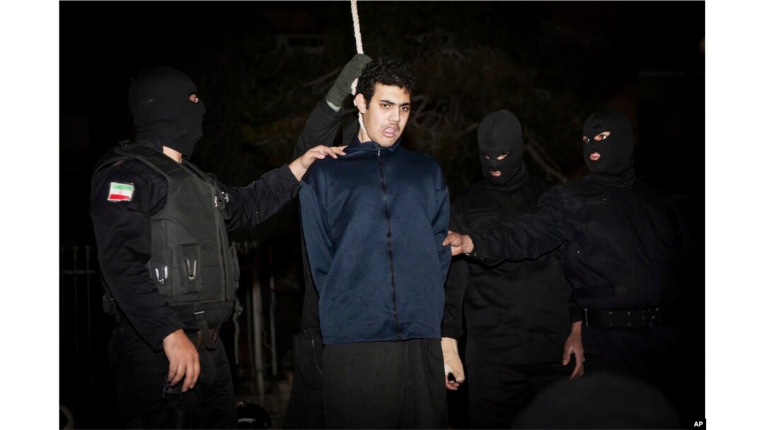 FILE - Iranian police prepare to hang a young convict in Tehran, Jan. 20, 2013.