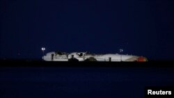 An Asiana Airlines Boeing 777 rests on the tarmac after crash landing at San Francisco International Airport in San Francisco, California, July 6, 2013. 