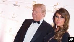 FILE - Donald Trump and Melania Trump attend a benefit at Trump Tower in New York, Nov. 19, 2014.