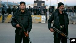 FILE - Pakistani security forces stand guard outside the parliament in Islamabad, Nov. 16, 2015.