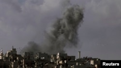 Smoke rises over the Salah al-Din neighborhood in central Aleppo, Syria, March 2, 2013.