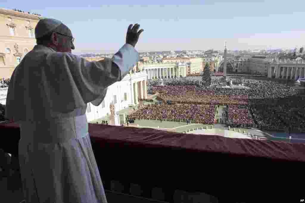 Pope Francis waves to faithful during the Urbi et Orbi (Latin for ' to the city and to the world') Christmas' day blessing from the main balcony of St. Peter's Basilica at the Vatican, Dec. 25, 2017.