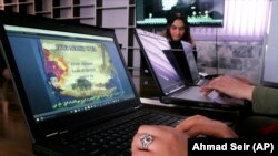 In this Monday, Jan. 22, 2018 photo, Afghan coders practice at the Code to Inspire computer training center in Herat province, western Afghanistan. (AP Photo/Ahmad Seir)