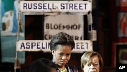 U.S. first lady Michelle Obama (C) and her mother Marian Robinson (R) listens to Bonita Bennett, director, as they visit the District Six museum, in Cape Town, South Africa, June 23, 2011