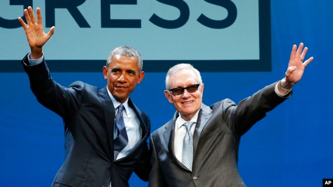 FILE - President Barack Obama, left, and Senate Minority Leader Sen. Harry Reid wave onstage at the National Clean Energy Summit, Aug. 24, 2015, in Las Vegas.