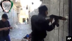 In this image taken from video obtained from the Ugarit News, which has been authenticated based on its contents and other AP reporting, Syrian rebels clash with government forces in Damascus, Syria, May 3, 2013.
