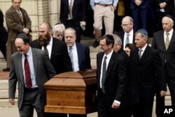 A casket is carried out of Rodef Shalom Congregation after the funeral services for brothers Cecil and David Rosenthal, Tuesday, Oct. 30, 2018, in Pittsburgh. The brothers were killed in the mass shooting Saturday at the Tree of Life synagogue. (AP..