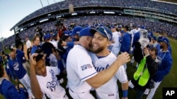 Kansas City Royals' Alex Gordon, right, celebrates with teammates after the Royals defeated the Baltimore Orioles to win the American League baseball championship series Wednesday, Oct. 15, 2014.
