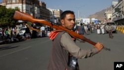 A Houthi Shi'ite rebel joins protests against Saudi-led airstrikes at a rally in Sana'a, Yemen, April 1, 2015. The air raids hit Shi'ite rebel positions in both north and south Yemen.