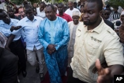 Gambia President elect, Adama Barrow, center, walks after a meeting with Ecowas delegation in Banjul, Gambia, Dec. 13, 2016.