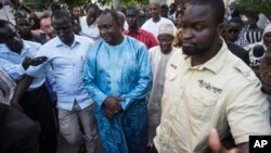 Gambian President-elect Adama Barrow, center, walks after meeting with an Ecowas delegation in Banjul, Gambia, Dec. 13, 2016.