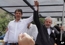 FILE - Brazil's former President Luiz Inacio Lula da Silva, right, campaigns with Sao Paulo's Mayor Fernando Haddad in Sao Paulo, Brazil, Sept. 30, 2016.