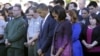 President Barack Obama, first lady Michelle Obama, and members of the White House staff pause during a moment of silence to mark the 11th anniversary of the September 11, 2001 terrorist attacks, on the South Lawn of the White House, in Washington, Septemb
