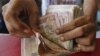 In India, Cash Replaces Food Rations for Poor 