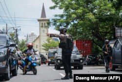 Seorang polisi mengatur lalu lintas setelah ledakan di luar sebuah gereja di Makassar pada 28 Maret 2021. (Foto: AFP/Daeng Mansur)