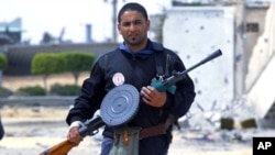 A rebel fighter takes position in the frontline at Tripoli street in Misrata. Tripoli street is the scene of some of the heaviest fighting between rebels and Gaddafi forces, April 21, 2011