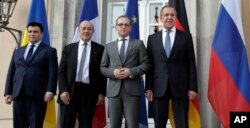 From left, the foreign ministers from Ukraine, Pavlo Klimkin, France, Jean-Yves Le Drian, Germany, Heiko Maas, and Russia, Sergey Lavrov, pose for the media before a meeting in Berlin, June 11, 2018.