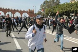 Protesting teachers run from security forces attempting to disperse a demonstration in Rabat, Morocco, Feb. 20, 2019.