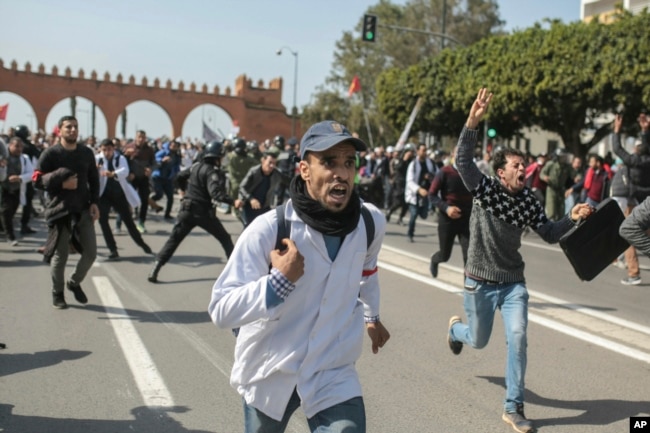 Protesting teachers run from security forces attempting to disperse a demonstration in Rabat, Morocco, Feb. 20, 2019.