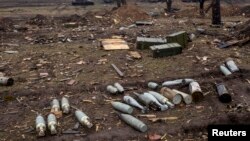 FILE - Ammunition at a field in the town of Debaltseve, northeast from Donetsk, March 13, 2015.