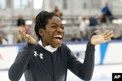 Maame Biney reacts during a medal ceremony after winning the women’s 500-meter race during the U.S. Olympic short track speedskating trials, Dec. 16, 2017, in Kearns, Utah.