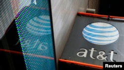 FILE - The signage for an AT&T store is seen in New York, Oct. 29, 2014. AT&T is one of the world's pioneering telecommunications companies, whose roots go back to the invention of the telephone in 1879.